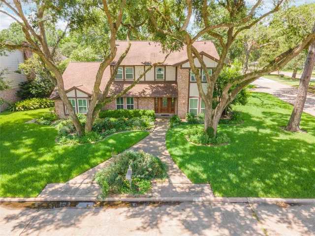 a aerial view of a house with a yard and potted plants
