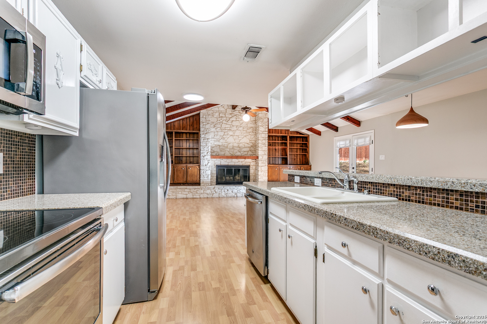5302 Fair Ridge Drive San Antonio, TX 78228 - Photo 15 of 24 a kitchen with stainless steel appliances granite countertop a sink and a stove