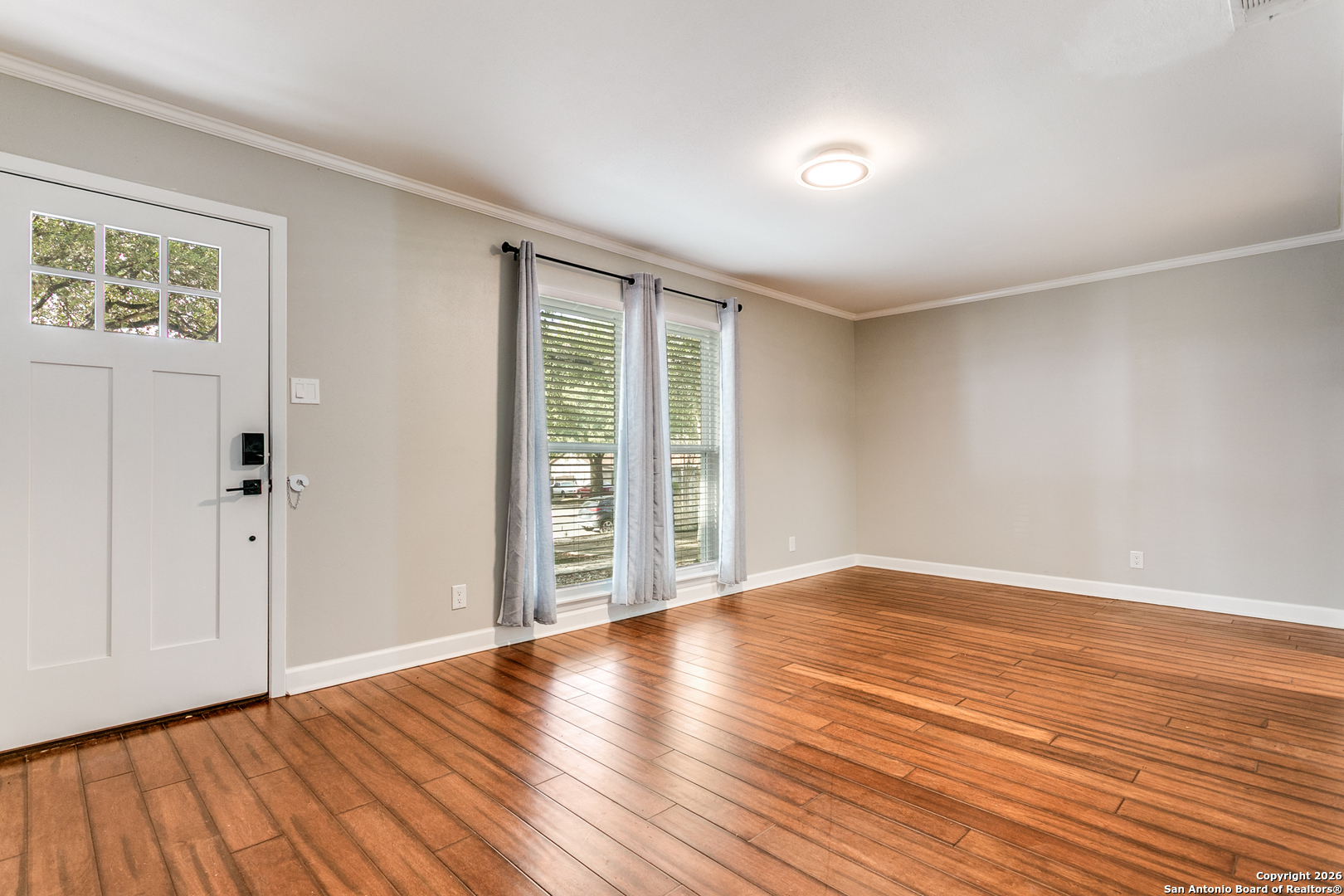 5302 Fair Ridge Drive San Antonio, TX 78228 - Photo 3 of 24 a view of an empty room with wooden floor and a window