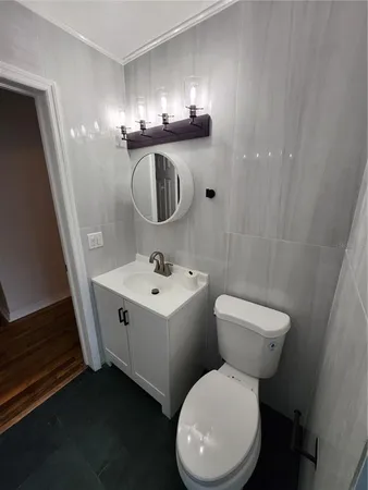 a white toilet sitting next to a bathroom sink
