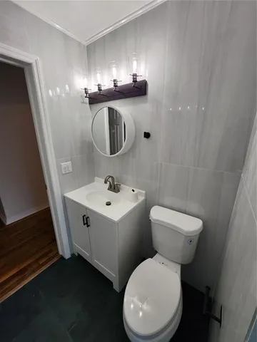 a white toilet sitting next to a bathroom sink
