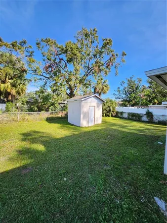 a view of a field with plants and trees