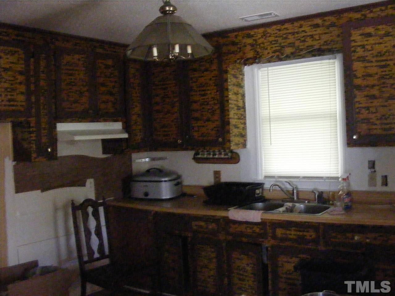 900 Clayton Road Durham, NC 27703 - Photo 3 of 10 a kitchen with a sink cabinets and window