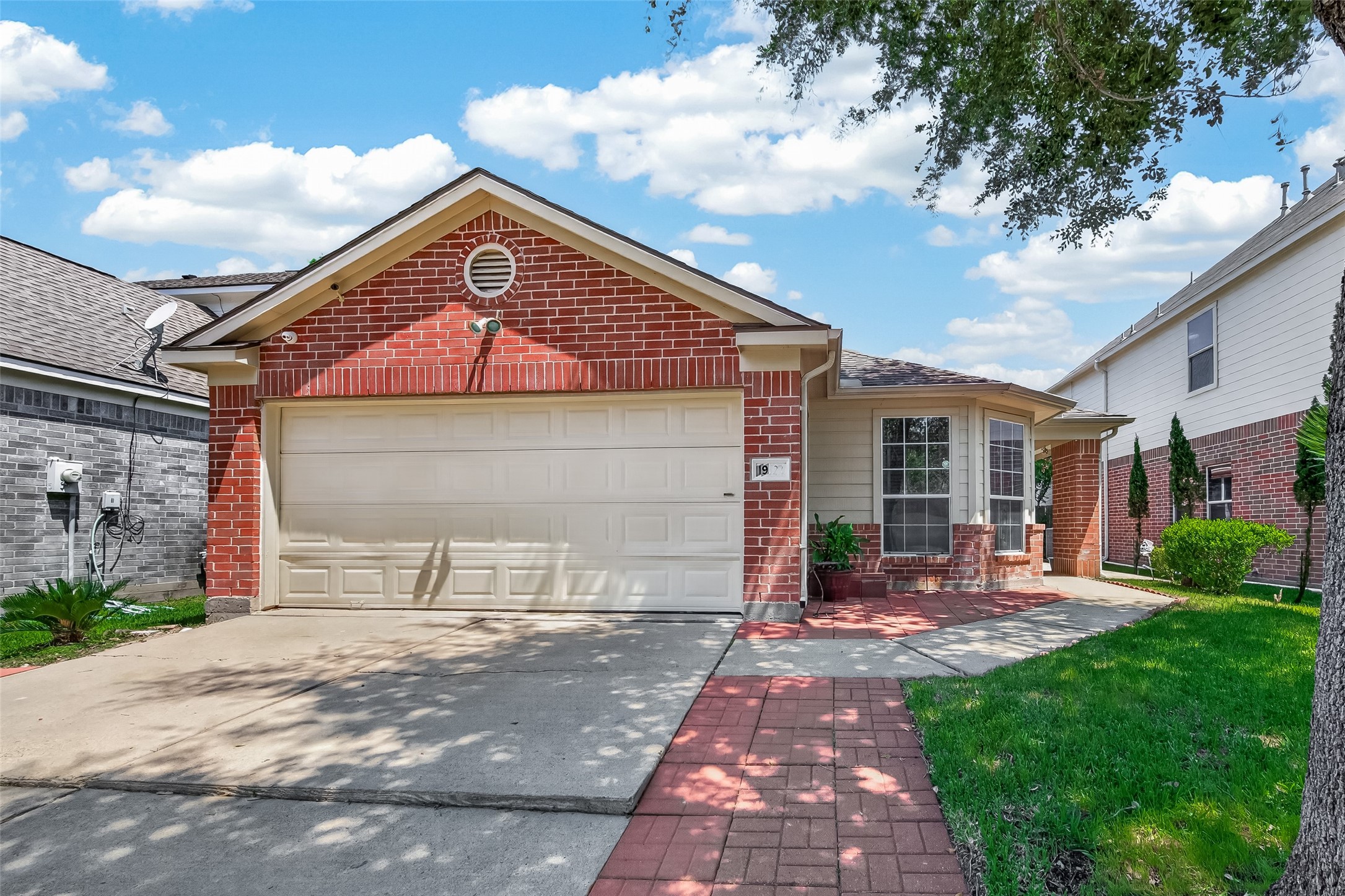 19322 Dawn Canyon Road Houston, TX 77084 - Photo 1 of 37 Charming brick-front features a well-maintained lawn and a cozy porch area.