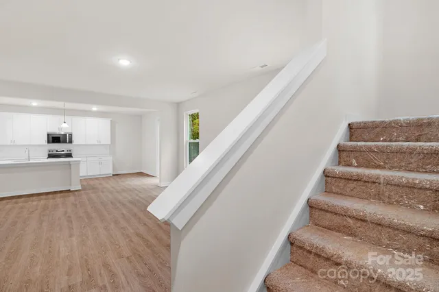 a view of an entryway with wooden floor