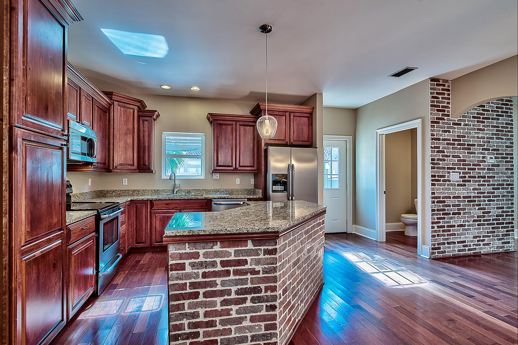 239 Inverrary Drive Destin, FL 32541 - Photo 13 of 20 a kitchen with stainless steel appliances granite countertop a stove a sink dishwasher and a refrigerator