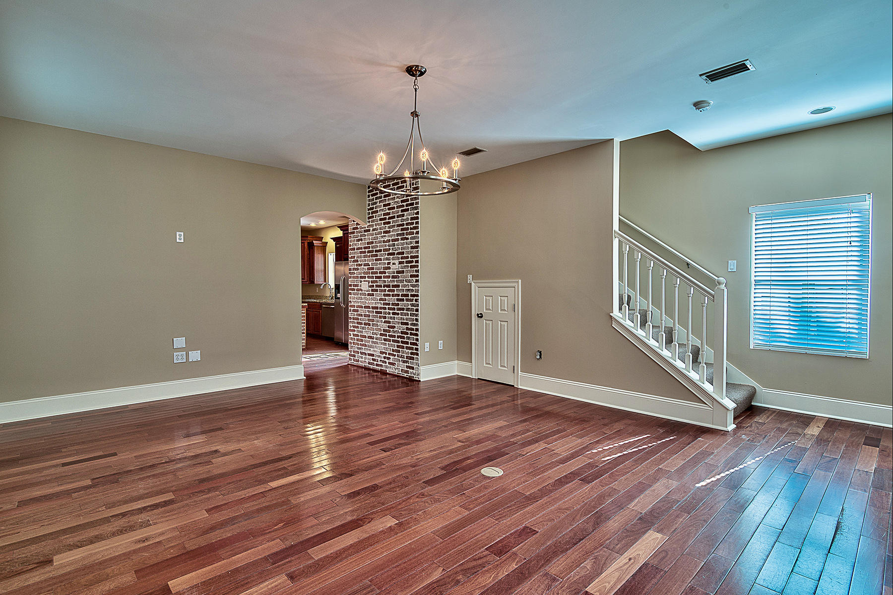 239 Inverrary Drive Destin, FL 32541 - Photo 15 of 20 a view of an empty room with wooden floor and staircase