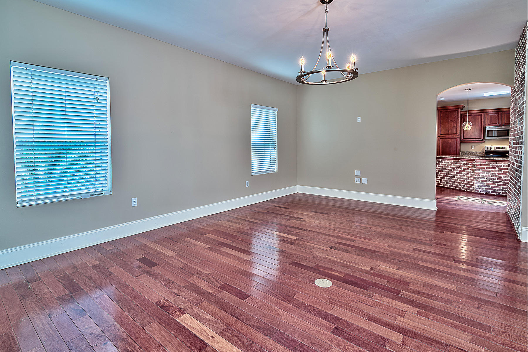 239 Inverrary Drive Destin, FL 32541 - Photo 16 of 20 a view of a room with wooden floor and chandelier