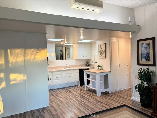 a kitchen with white cabinets and appliances