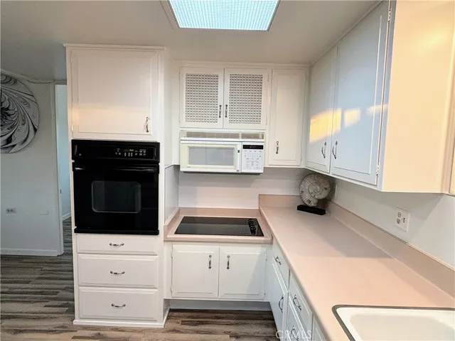 a kitchen with a refrigerator and a sink