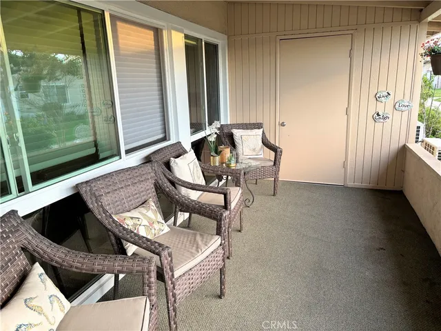 a dining room with wooden floor a glass table and chairs