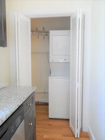 a utility room with cabinets washer and dryer