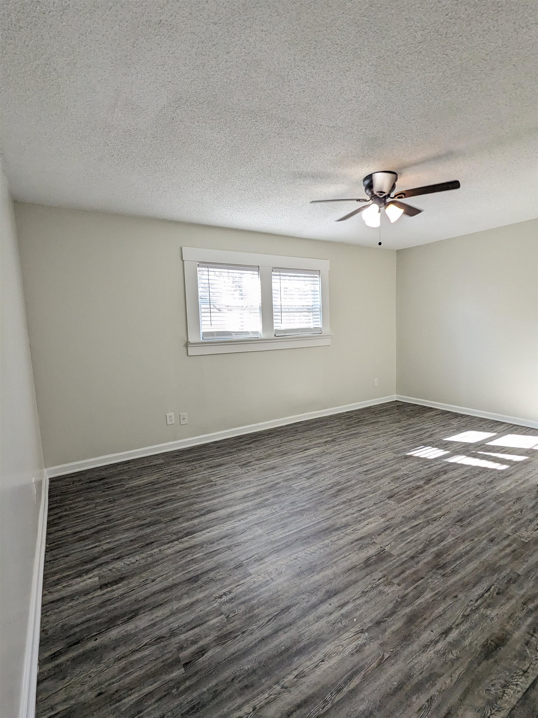 4499 Range Line Road Memphis, TN 38127 - Photo 6 of 10 wooden floor in an empty room with a window