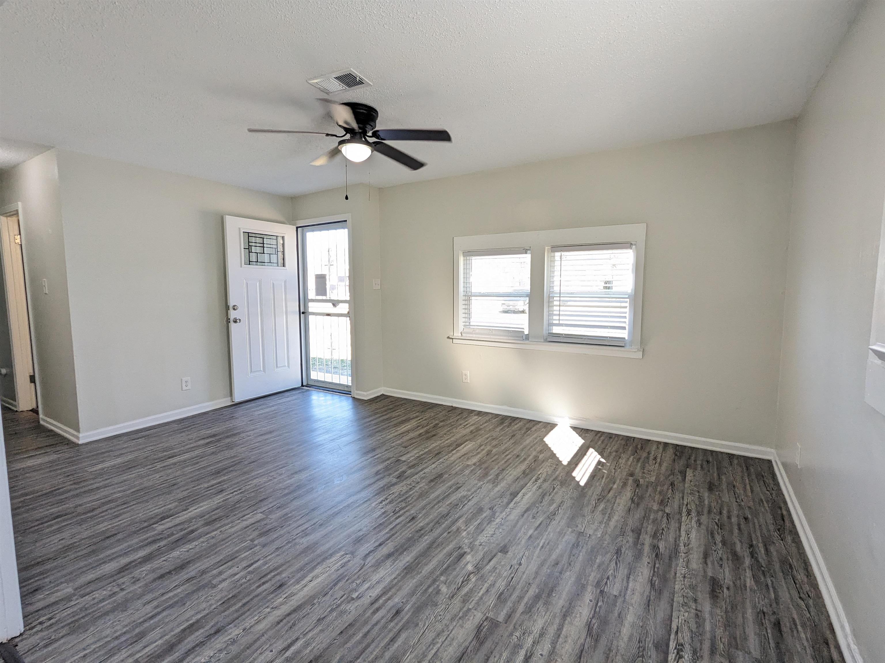 4499 Range Line Road Memphis, TN 38127 - Photo 7 of 10 a view of empty room with wooden floor and fan