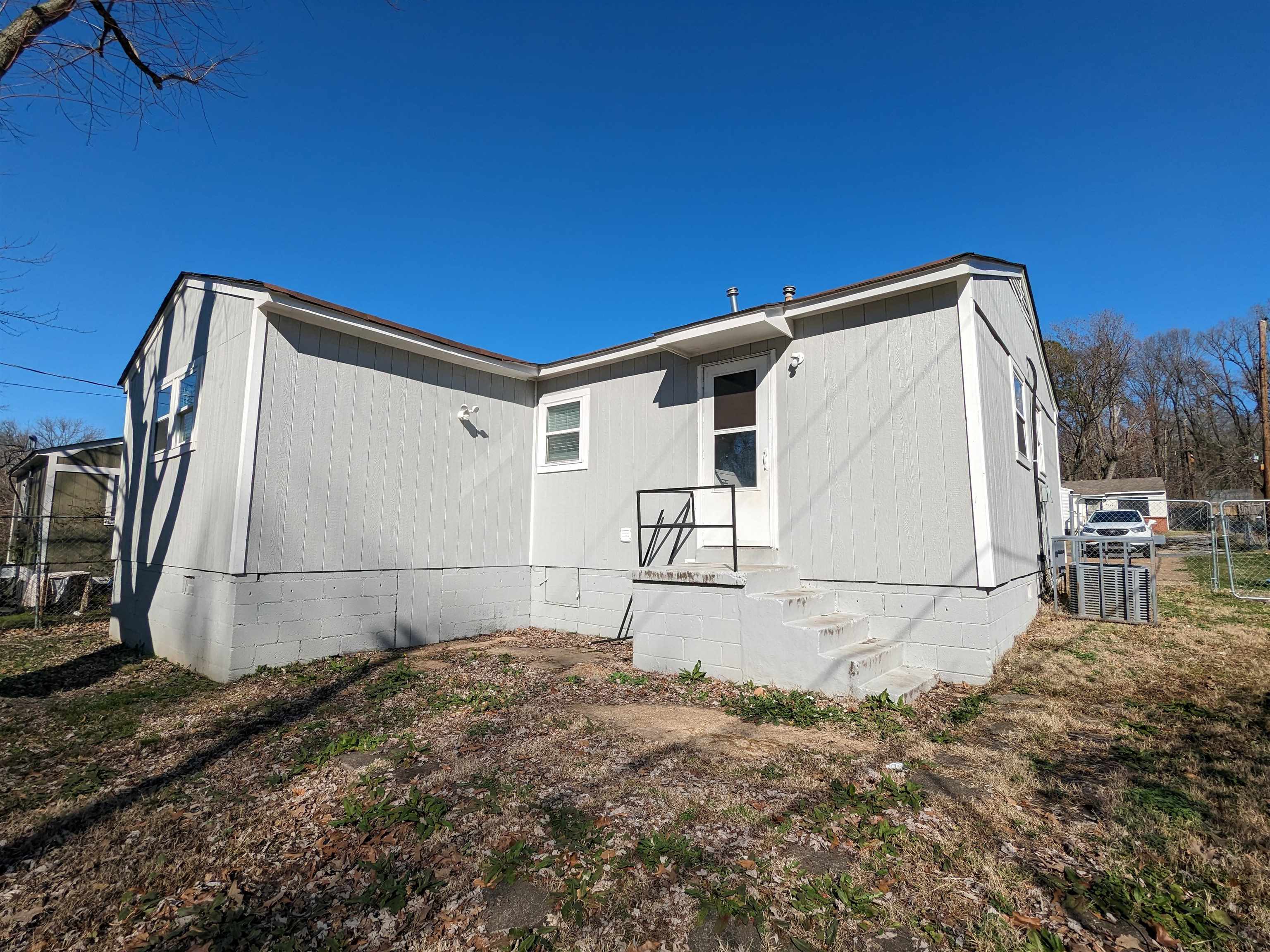 4499 Range Line Road Memphis, TN 38127 - Photo 8 of 10 a backyard of a house with basket ball court and wooden fence