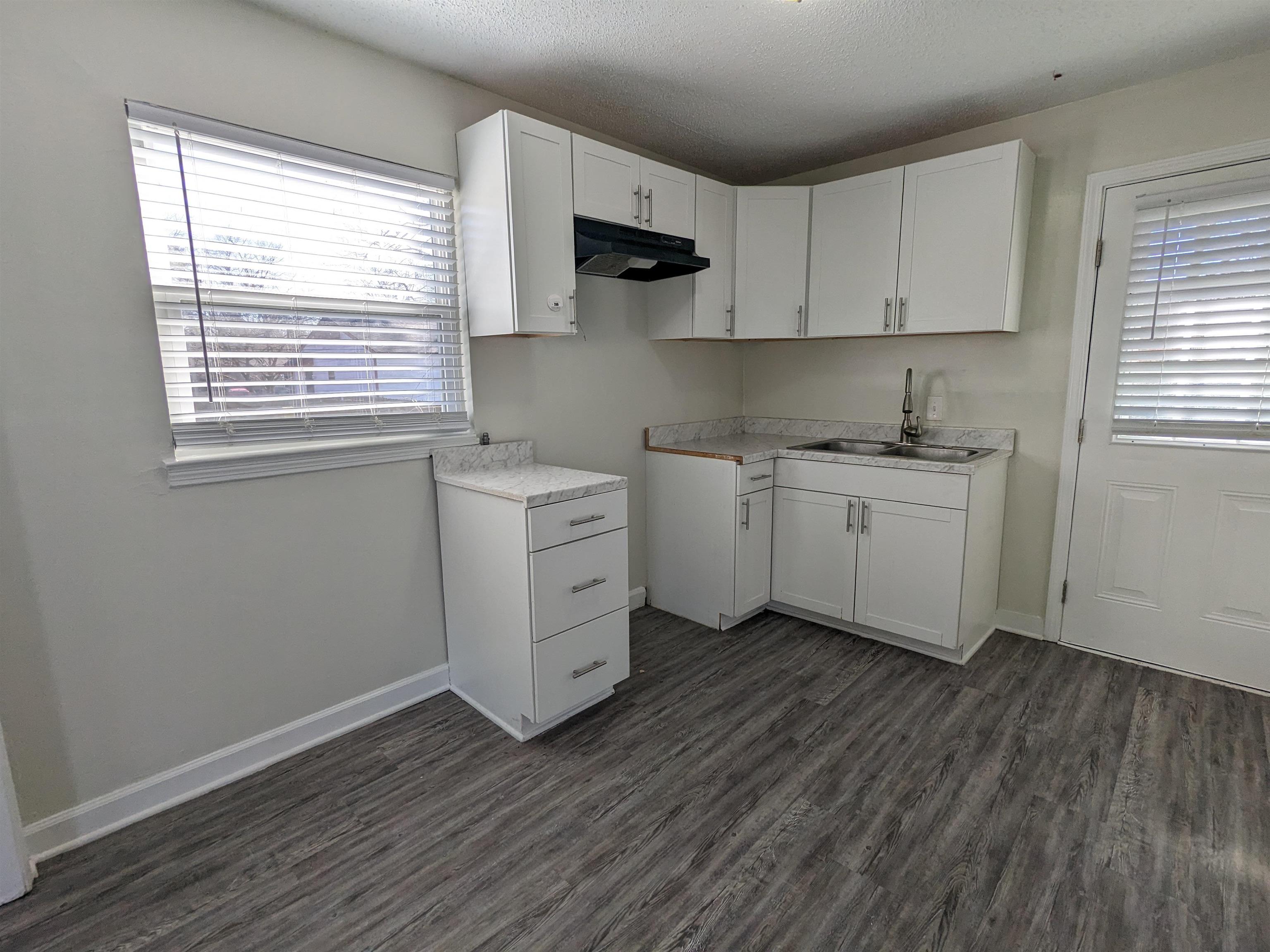 4499 Range Line Road Memphis, TN 38127 - Photo 10 of 10 a kitchen with stainless steel appliances a white stove top oven sink and cabinets