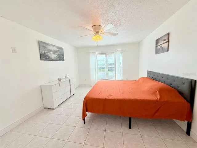 a bed sitting in a bedroom next to a window