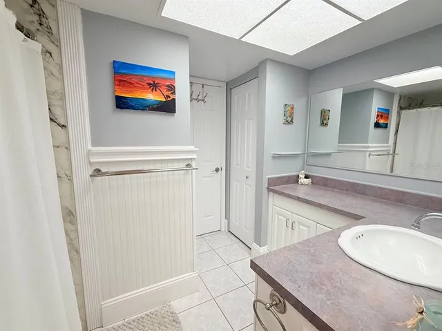 a bathroom with a sink a mirror and a shower