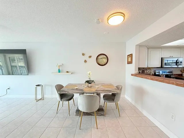 a view of a dining room with furniture and a chandelier