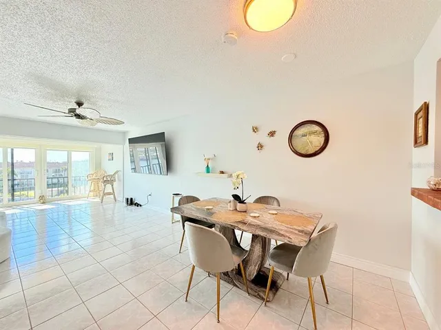 a view of a dining room with furniture and a large window