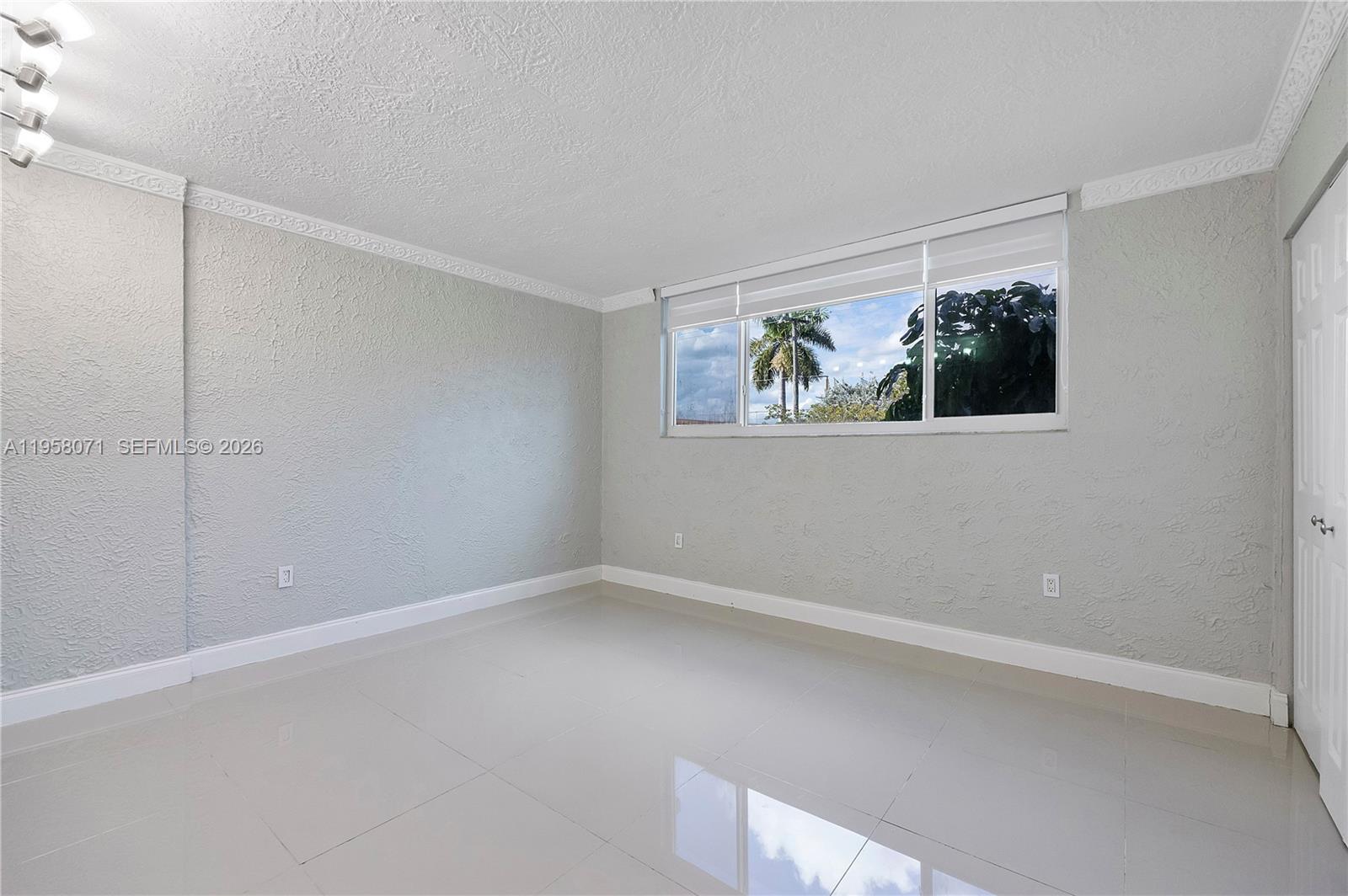 8050 Northwest 8th Street, Unit 1203 Miami, FL 33126 - Photo 9 of 14 a view of room with window