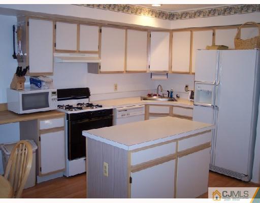 199 Nebula Road Piscataway, NJ 08854 - Photo 4 of 10 a kitchen with a sink a stove a refrigerator and cabinets