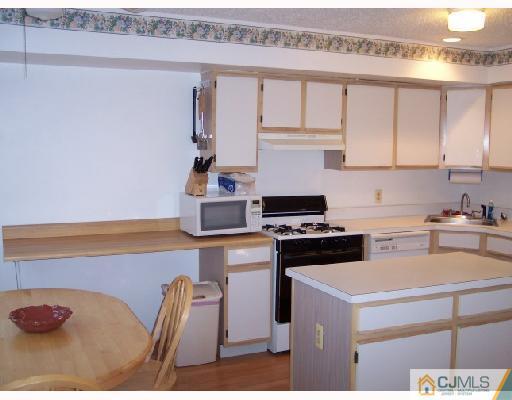 199 Nebula Road Piscataway, NJ 08854 - Photo 5 of 10 a kitchen with a stove and a white refrigerator