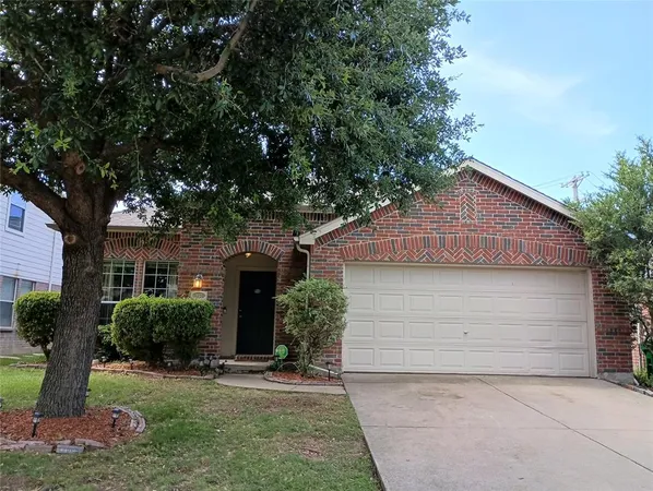 a front view of house with yard and trees