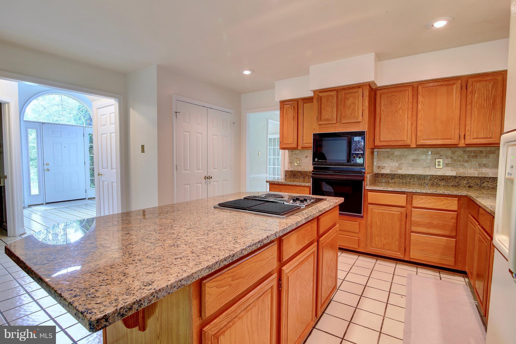 14515 Cutstone Way Silver Spring, MD 20905 - Photo 14 of 29 a kitchen with stainless steel appliances granite countertop wooden cabinets a stove top oven a sink and dishwasher
