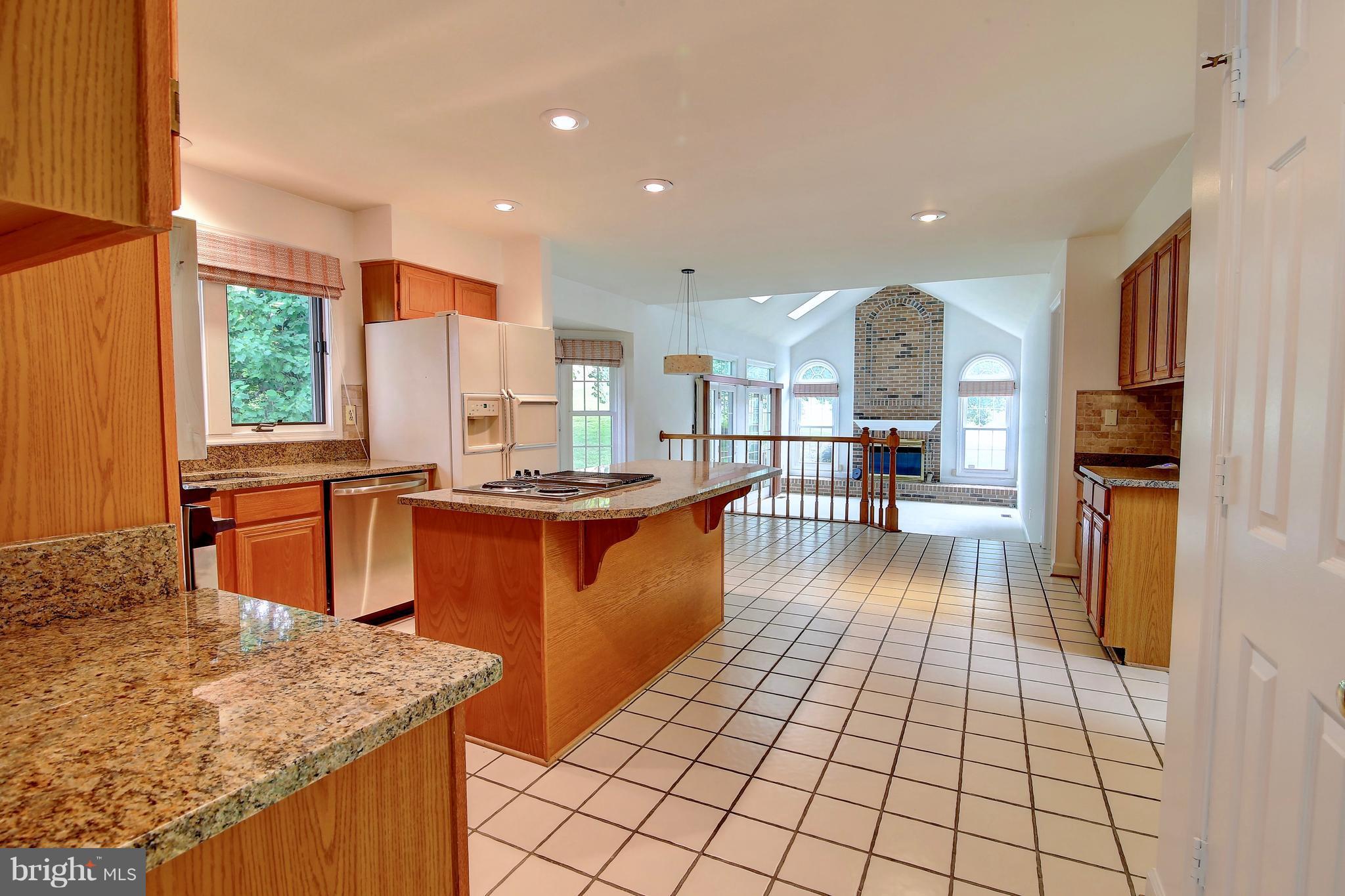 14515 Cutstone Way Silver Spring, MD 20905 - Photo 16 of 29 a kitchen with stainless steel appliances granite countertop a refrigerator a sink a stove and a wooden cabinets