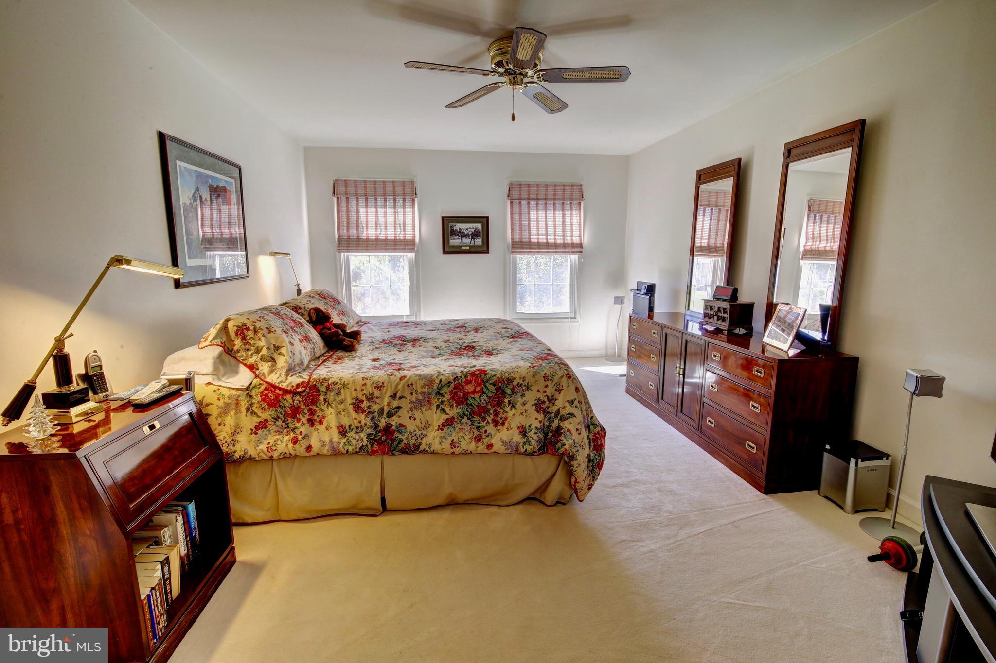 14515 Cutstone Way Silver Spring, MD 20905 - Photo 17 of 29 a bedroom with a bed and wooden floor