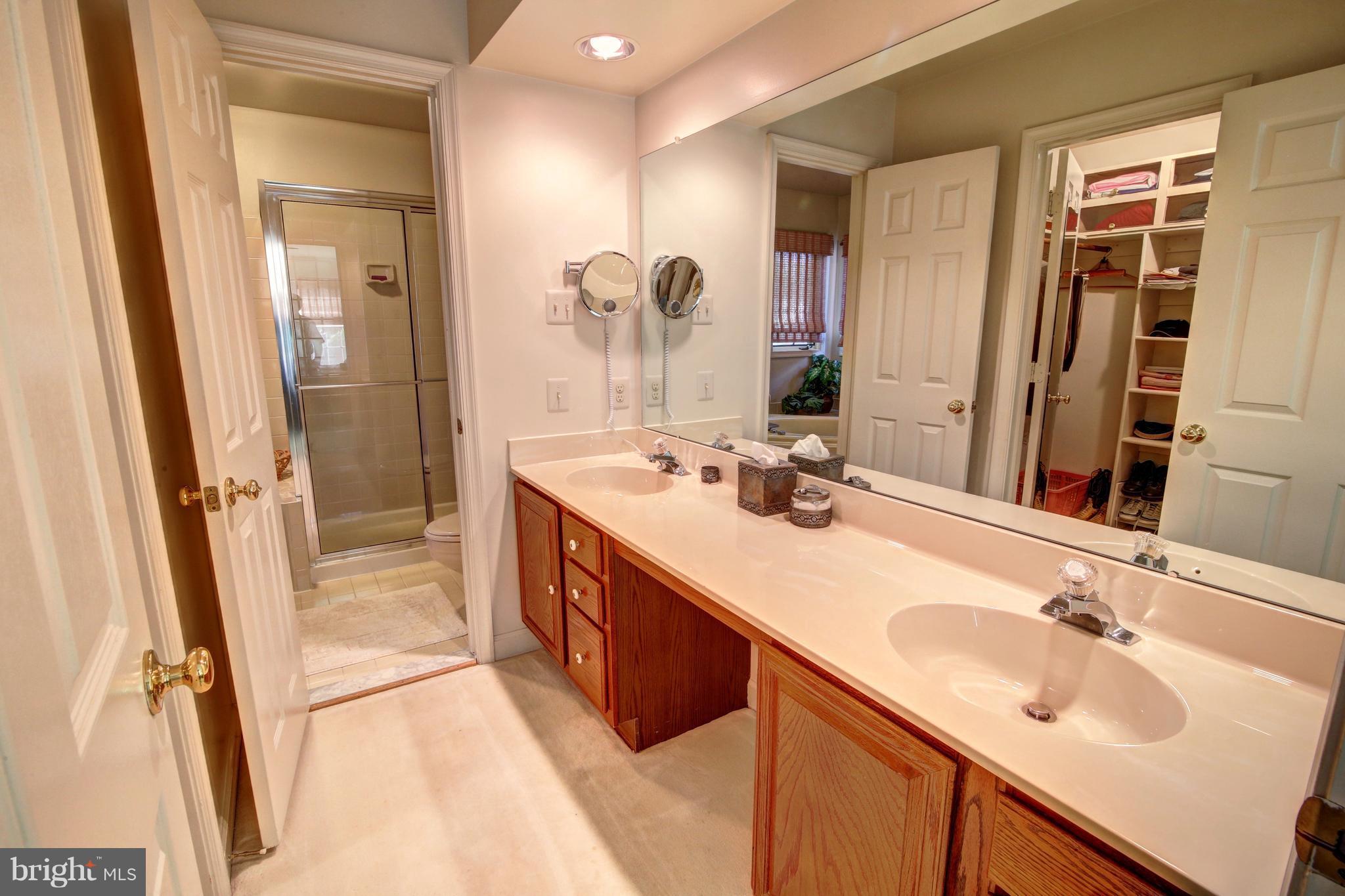 14515 Cutstone Way Silver Spring, MD 20905 - Photo 18 of 29 a bathroom with a double vanity sink mirror and double
