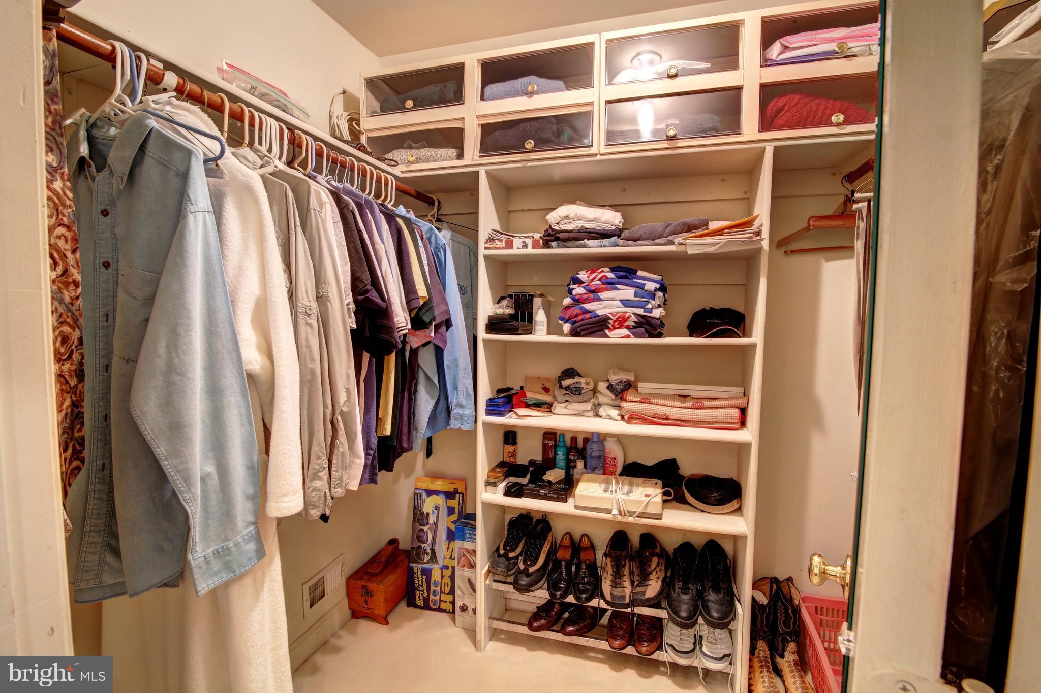 14515 Cutstone Way Silver Spring, MD 20905 - Photo 20 of 29 a view of walk in closet with clothes and shoes