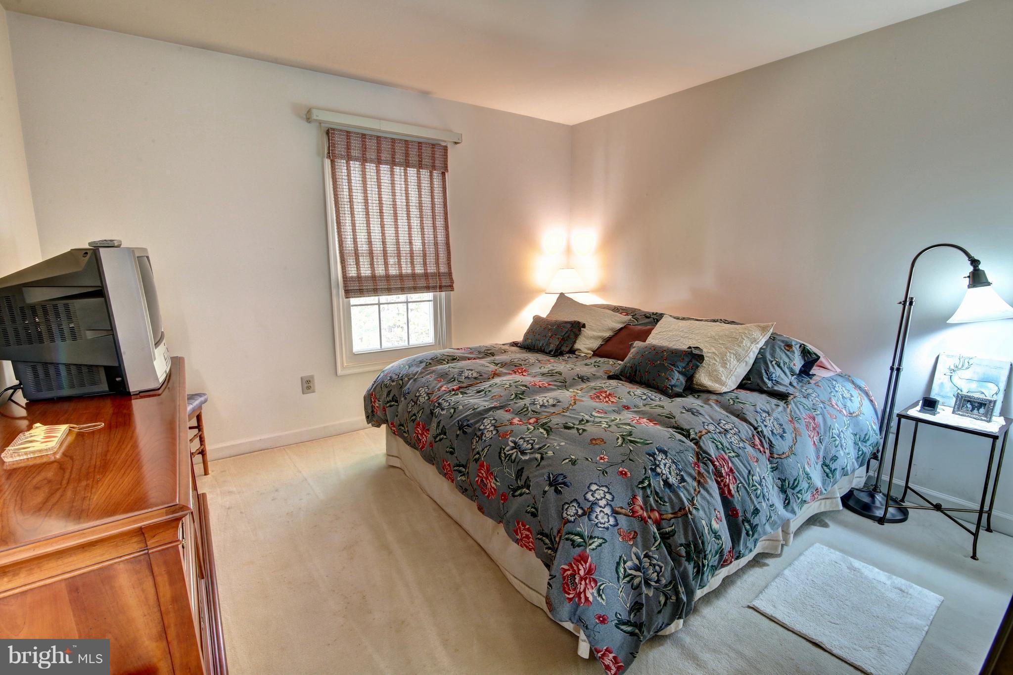 14515 Cutstone Way Silver Spring, MD 20905 - Photo 22 of 29 a bed sitting in a bedroom next to a window