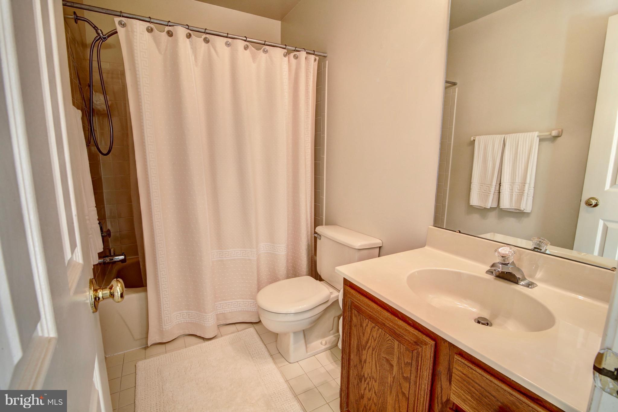 14515 Cutstone Way Silver Spring, MD 20905 - Photo 23 of 29 a bathroom with a sink toilet and shower