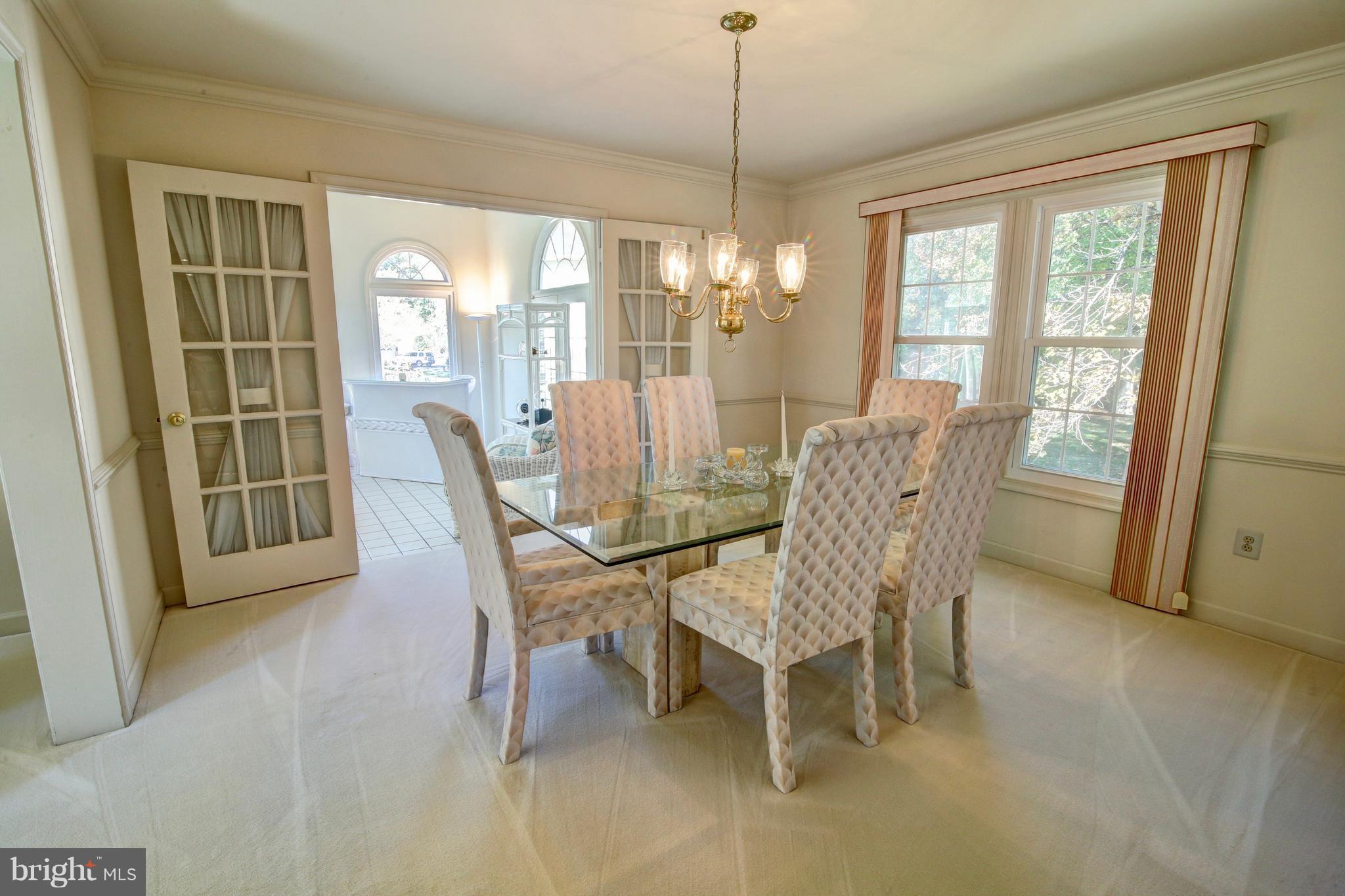 14515 Cutstone Way Silver Spring, MD 20905 - Photo 6 of 29 a view of a dining room with furniture large windows and wooden floor