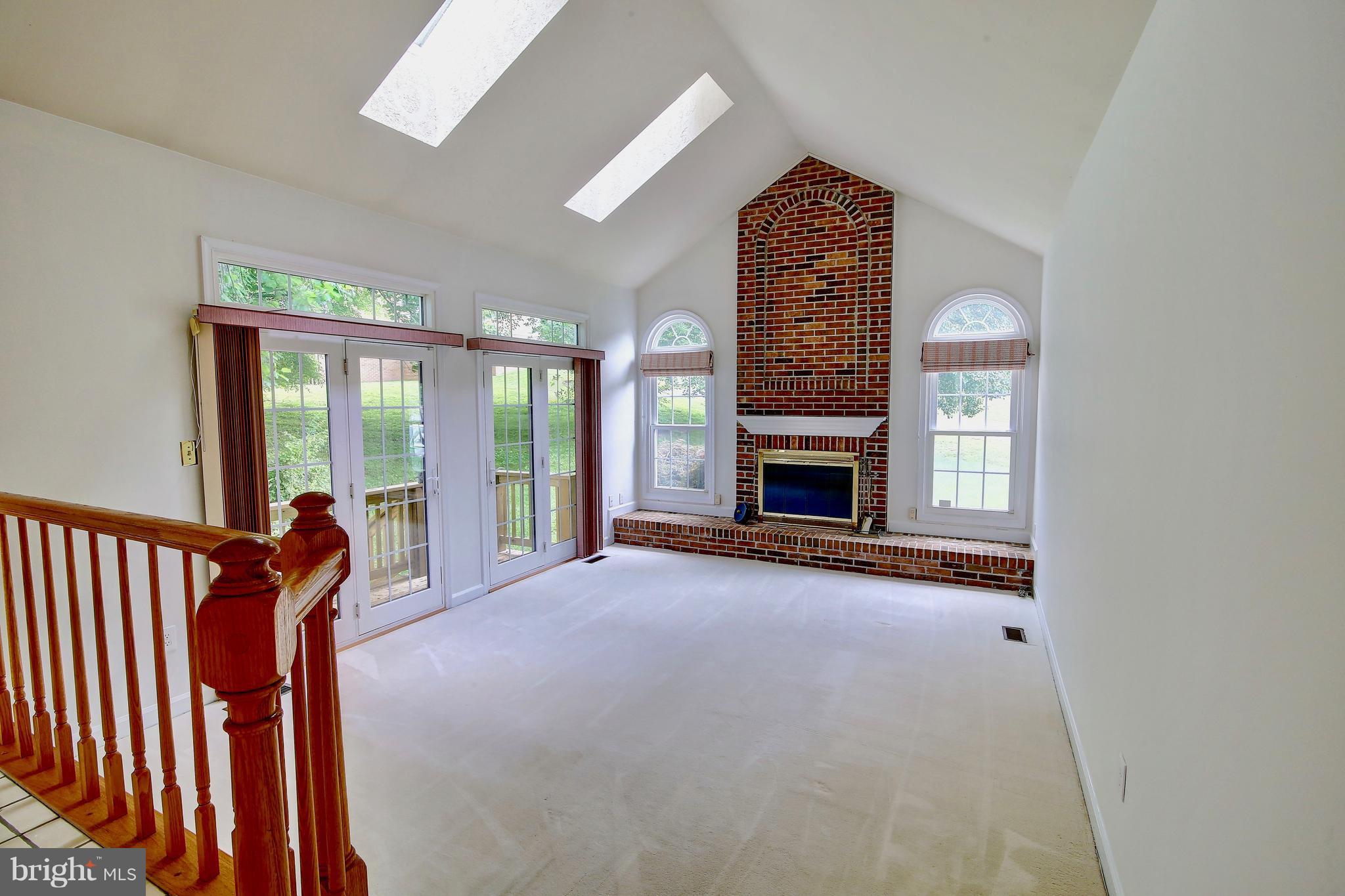 14515 Cutstone Way Silver Spring, MD 20905 - Photo 9 of 29 wooden floor in an empty room with a fireplace