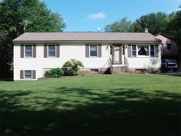 1235 Bemis Road Warren, MA 01083 - Photo 2 of 20 a front view of a house with a garden