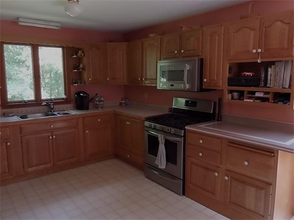 1235 Bemis Road Warren, MA 01083 - Photo 8 of 20 a kitchen with sink a microwave a stove and cabinets