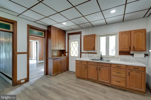 a large kitchen with a large window and stainless steel appliances
