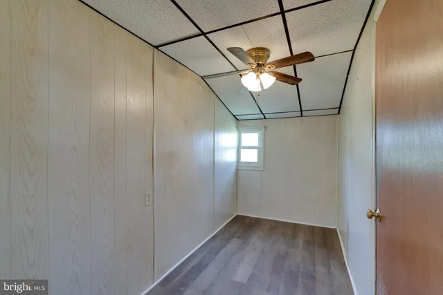 a view of a room with wooden floor and fan