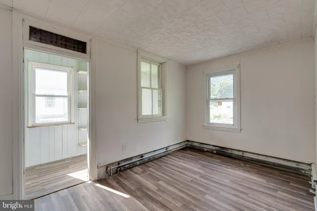a view of a room with wooden floor and window