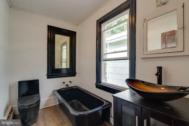 a kitchen with a sink cabinets and a window
