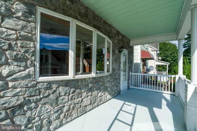 a view of house with a porch
