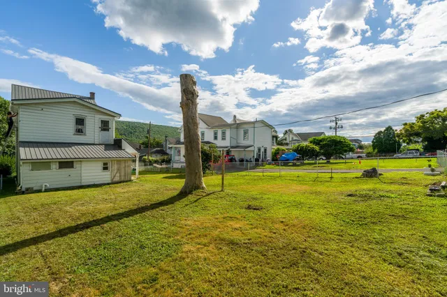 a swimming pool with outdoor seating and yard