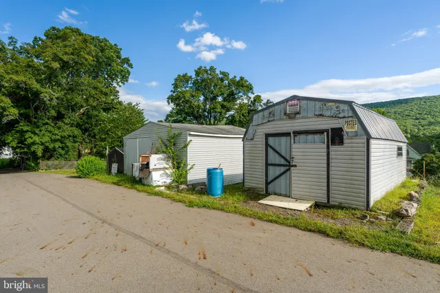 a view of a house with a yard and garage