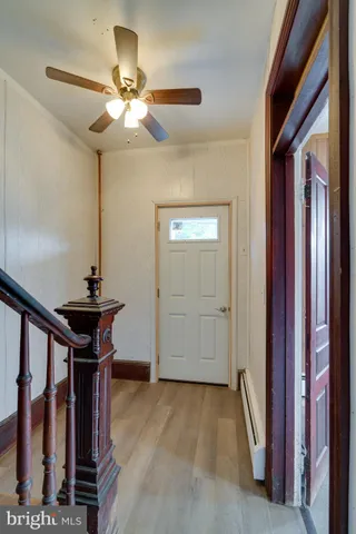 a view of a livingroom with a chandelier fan and furniture