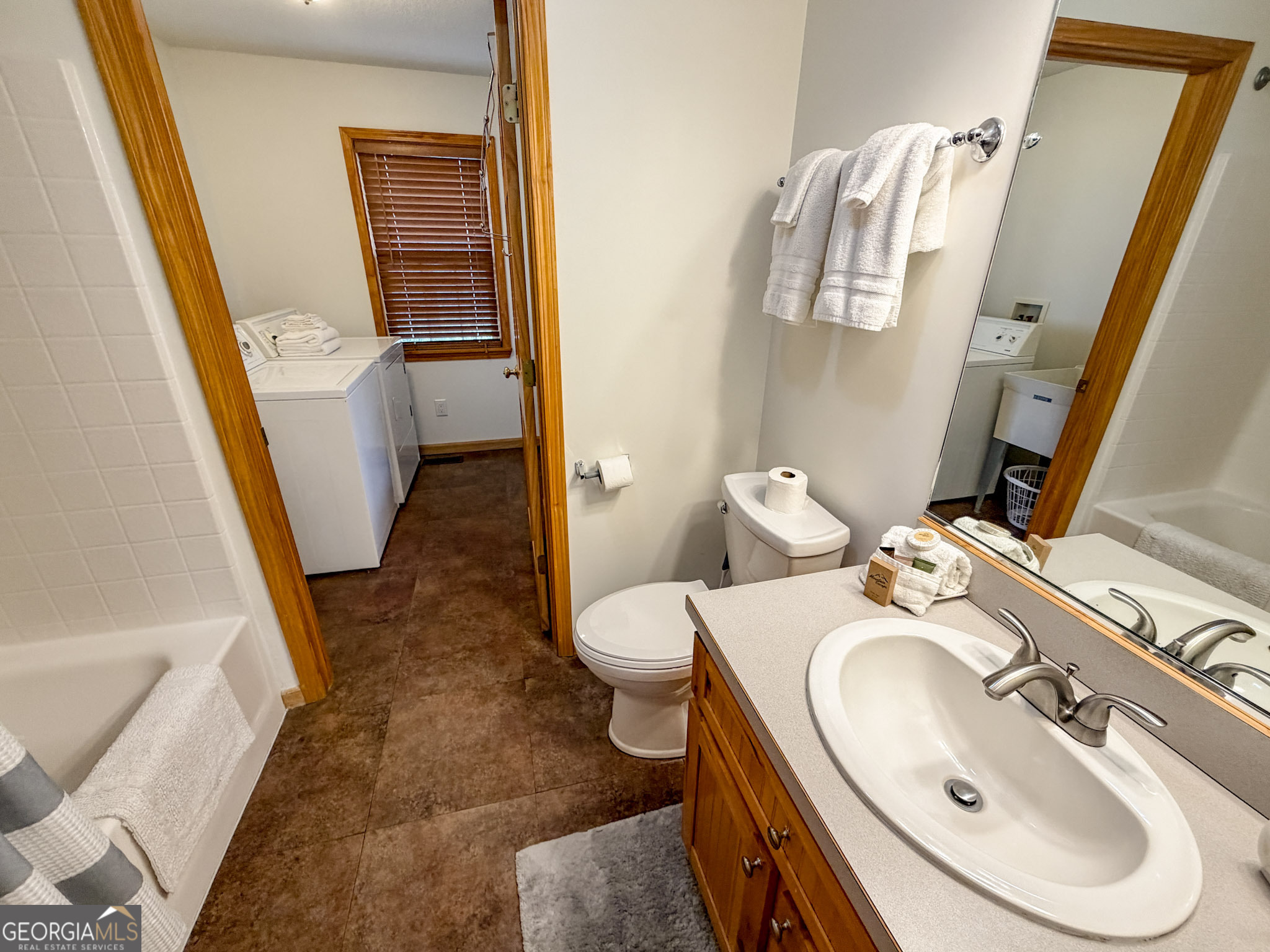 703 Zeppelin Strasse Helen, GA 30545 - Photo 13 of 28 a bathroom with a sink and mirror with toilet