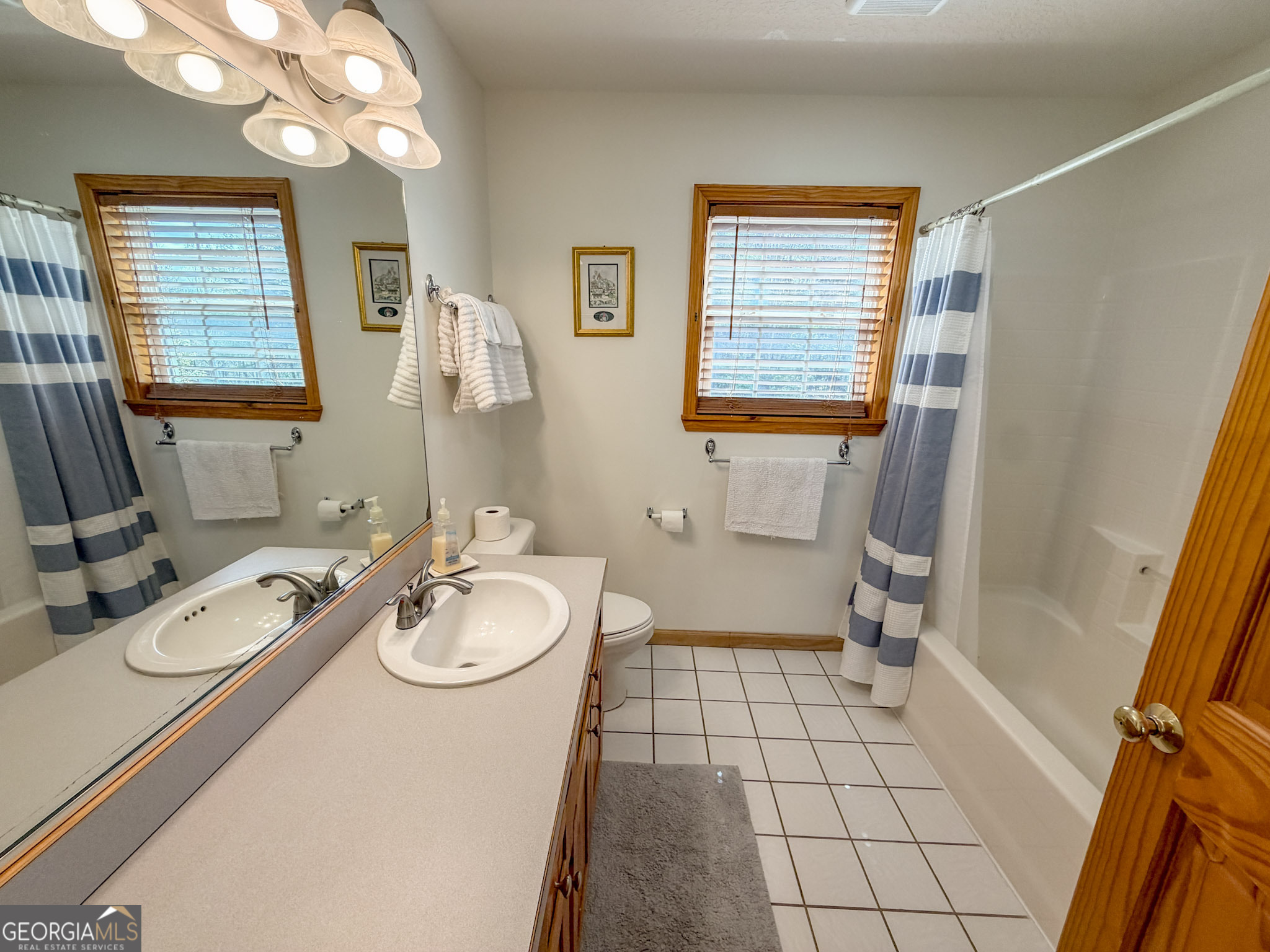 703 Zeppelin Strasse Helen, GA 30545 - Photo 17 of 28 a bathroom with a sink a toilet a mirror and shower