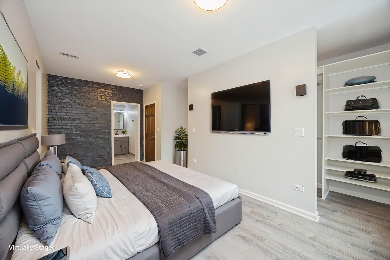 2008 West Addison Street, Unit 2 Chicago, IL 60618 - Photo 14 of 19 a bedroom with a bed and a flat screen tv